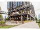 Outdoor restaurant patio with modern building architecture and dining spaces, plants, and city views at 1937 Wilmore Dr, Charlotte, NC 28203