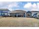 Spacious backyard featuring a well-maintained lawn, swingset, and patio with outdoor seating at 2056 Angel Oak Dr, Fort Mill, SC 29715