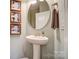 Charming powder room with pedestal sink, oval mirror, and playful decorative art at 2056 Angel Oak Dr, Fort Mill, SC 29715