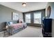 Charming bedroom with two windows, a cozy daybed, and stylish decor for a relaxing retreat at 2056 Angel Oak Dr, Fort Mill, SC 29715