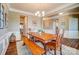 Dining room features a wooden table, bench, and chairs, illuminated by a modern chandelier at 2056 Angel Oak Dr, Fort Mill, SC 29715