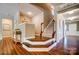 Grand two-story foyer with hardwood floors, staircase, and elegant decorative accents at 2056 Angel Oak Dr, Fort Mill, SC 29715