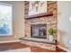 Close-up of stone fireplace with wooden mantle and adjacent window at 2056 Angel Oak Dr, Fort Mill, SC 29715