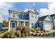 Charming two-story home with blue siding, white trim, and a well-manicured front yard at 2056 Angel Oak Dr, Fort Mill, SC 29715
