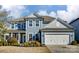 Charming two-story home with blue siding, white trim, and a well-manicured front yard at 2056 Angel Oak Dr, Fort Mill, SC 29715