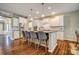 A kitchen with white cabinets, stainless steel appliances, an island with seating, and hardwood floors at 2056 Angel Oak Dr, Fort Mill, SC 29715