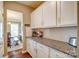 Kitchen with white cabinets and granite countertops, complemented by stainless steel appliances and hardwood floors at 2056 Angel Oak Dr, Fort Mill, SC 29715