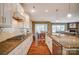 Open-concept kitchen with white cabinets, granite countertops, and stainless steel appliances at 2056 Angel Oak Dr, Fort Mill, SC 29715