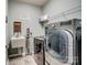 Convenient laundry room with modern washer/dryer, utility sink, and storage shelf at 2056 Angel Oak Dr, Fort Mill, SC 29715