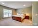 Spacious bedroom with a large window and ample natural light; featuring a king sized bed at 2056 Angel Oak Dr, Fort Mill, SC 29715