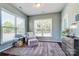 Comfortable sitting room bathed in natural light, featuring a cozy armchair, ottoman, and plush rug at 2056 Angel Oak Dr, Fort Mill, SC 29715