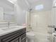 Clean bathroom with a shower-tub combo, stylish vanity, and neutral tile at 2100 Bluebonnet Ln, Matthews, NC 28104