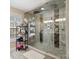 Walk-in shower with tile surround, a window, and decorative shelving at 2100 Bluebonnet Ln, Matthews, NC 28104