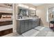 Bathroom featuring a dual sink vanity, decorative mirrors and lighting, and a view into bedroom at 2100 Bluebonnet Ln, Matthews, NC 28104