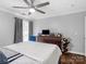 Bedroom featuring hardwood floors, ceiling fan, dresser and media center at 2100 Bluebonnet Ln, Matthews, NC 28104