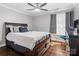 This bedroom has a ceiling fan and natural light coming in through the window with stylish curtains at 2100 Bluebonnet Ln, Matthews, NC 28104