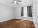 Cozy bedroom featuring hardwood floors, neutral walls, and a bright window at 2100 Bluebonnet Ln, Matthews, NC 28104