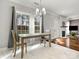 Bright dining area features elegant lighting, large windows, and views into the adjacent living room at 2100 Bluebonnet Ln, Matthews, NC 28104