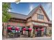 Exterior shot of Poppeyseeds Bagels, featuring umbrellas with Boar's Head logos at 2100 Bluebonnet Ln, Matthews, NC 28104