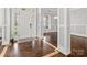 Welcoming foyer with beautiful herringbone floors, natural light, and white columns at 2100 Bluebonnet Ln, Matthews, NC 28104