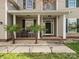Inviting front porch with decorative columns and comfortable seating at 2100 Bluebonnet Ln, Matthews, NC 28104