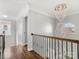Elegant hallway featuring a stunning chandelier and hardwood floors at 2100 Bluebonnet Ln, Matthews, NC 28104