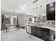 Modern kitchen showcasing dark cabinets, stylish countertops, stainless steel appliances, and an adjacent dining area at 2100 Bluebonnet Ln, Matthews, NC 28104