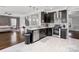Modern eat-in kitchen with stainless steel appliances and breakfast bar at 2100 Bluebonnet Ln, Matthews, NC 28104