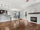 Open-concept space features a modern fireplace and wood floors at 2100 Bluebonnet Ln, Matthews, NC 28104