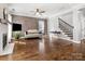 Spacious living room boasts hardwood floors, a cozy sofa, and a striking wood accent wall at 2100 Bluebonnet Ln, Matthews, NC 28104