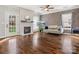 Bright living room features a modern fireplace, wood flooring, and large windows at 2100 Bluebonnet Ln, Matthews, NC 28104