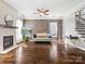Bright living room features a modern fireplace, wood flooring, and large windows at 2100 Bluebonnet Ln, Matthews, NC 28104
