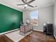 Bright home office with green accent wall, modern desk, hardwood floors and a large window at 2100 Bluebonnet Ln, Matthews, NC 28104