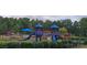 A colorful community playground with slides and climbing equipment provides a fun space for to play at 2100 Bluebonnet Ln, Matthews, NC 28104
