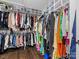 Spacious walk-in closet offering ample storage with shelves and rods, and hardwood floors at 2100 Bluebonnet Ln, Matthews, NC 28104