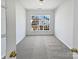 This is a bright, carpeted bedroom with a large window bringing in natural light at 21005 Brinkley St, Cornelius, NC 28031