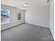 A bright bedroom featuring neutral walls, carpet, and two windows offering natural light at 21005 Brinkley St, Cornelius, NC 28031