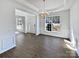 Dining room with wood floors, a modern chandelier and great natural light at 21005 Brinkley St, Cornelius, NC 28031