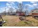 Expansive backyard with a fire pit, chairs, and a view of the detached garage at 2320 Monterey Park Dr, Gastonia, NC 28054