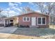 Charming brick ranch home with covered carport featuring outdoor seating and well-maintained yard at 2320 Monterey Park Dr, Gastonia, NC 28054