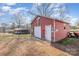 Detached red garage with an American flag, stop sign, and unique nautical-themed decor at 2320 Monterey Park Dr, Gastonia, NC 28054