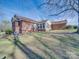 Spacious backyard with brick ranch house featuring sun room and shade trees at 2615 High Ridge Church Rd, Marshville, NC 28103