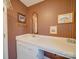 This bathroom has a long white counter and sink and an arched mirror at 2615 High Ridge Church Rd, Marshville, NC 28103