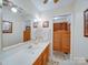 Traditional-style bathroom vanity featuring a wide mirror and wooden accents at 2615 High Ridge Church Rd, Marshville, NC 28103