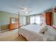 Large bedroom features a four-poster bed, a ceiling fan, and multiple wooden dressers at 2615 High Ridge Church Rd, Marshville, NC 28103