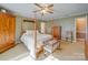 Comfortable bedroom featuring a wooden four-poster bed, ceiling fan and natural lighting at 2615 High Ridge Church Rd, Marshville, NC 28103