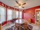 Sunny breakfast area features a round wooden table, colorful rug, and red walls decorated with decorative plates at 2615 High Ridge Church Rd, Marshville, NC 28103