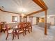 Spacious dining room featuring wood beam accents with easy access to the living room with fireplace at 2615 High Ridge Church Rd, Marshville, NC 28103
