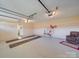 Spacious garage with white floor, room for parking, and area for storage with chair and decorations at 2615 High Ridge Church Rd, Marshville, NC 28103