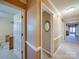 Hallway with neutral walls, white trim, and doorways leading to other rooms in the home at 2615 High Ridge Church Rd, Marshville, NC 28103